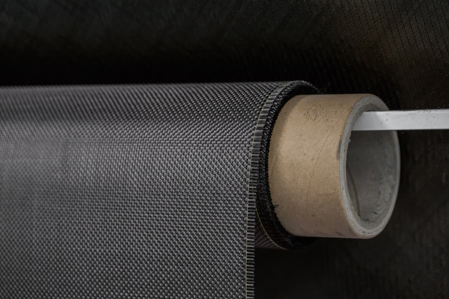 Close up of carbon fiber roll against a black background