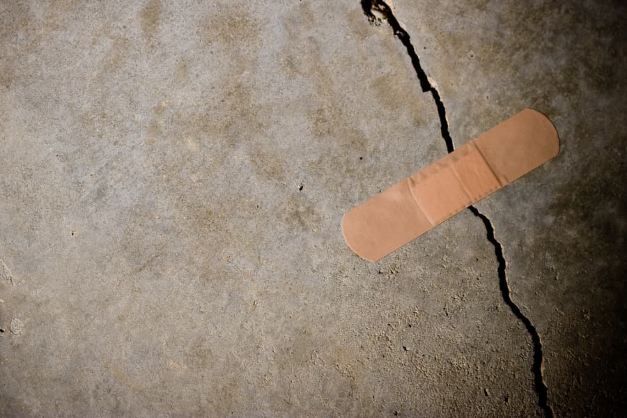 A basement wall is cracked by water damage