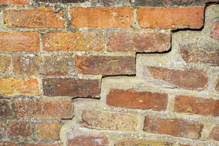 Basement Wall Made of Brick with A Crack That Needs To be Repaired